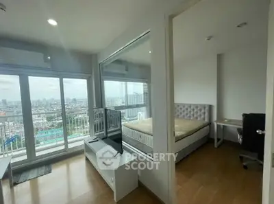 Modern apartment with city view, featuring a cozy bedroom and spacious living area.
