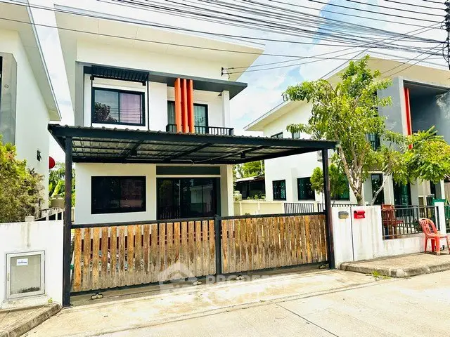 Modern two-story house with gated entrance and contemporary design