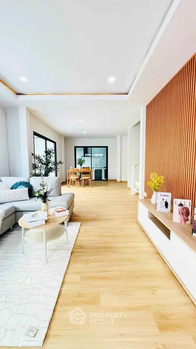 Spacious modern living room with wooden flooring and stylish decor