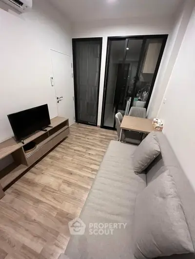 Modern living room with sleek furniture and wooden flooring