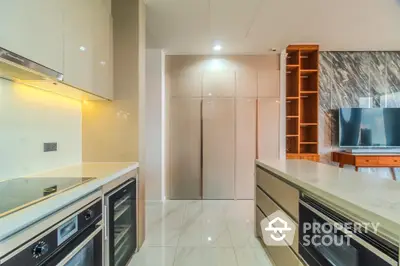 Modern kitchen with sleek cabinetry and built-in appliances in luxury apartment