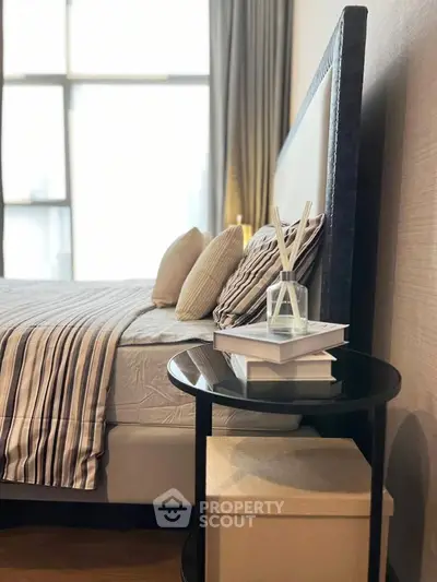 Elegant bedroom with stylish decor and large window for natural light