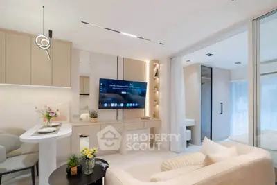 Modern living room with sleek design and open layout, featuring a wall-mounted TV and elegant decor.