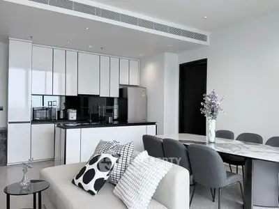 Modern open-layout kitchen and dining area with sleek design and stylish decor.