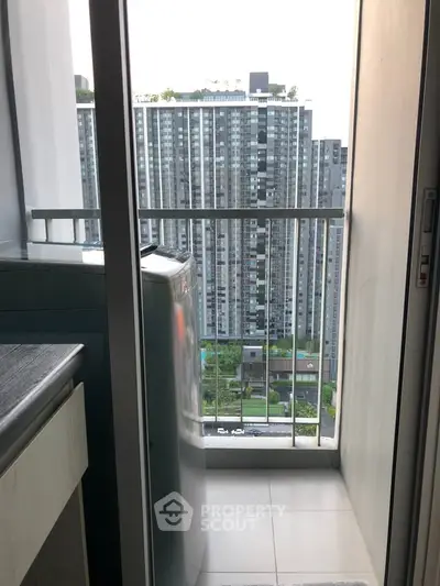 Modern apartment balcony with washing machine and city view