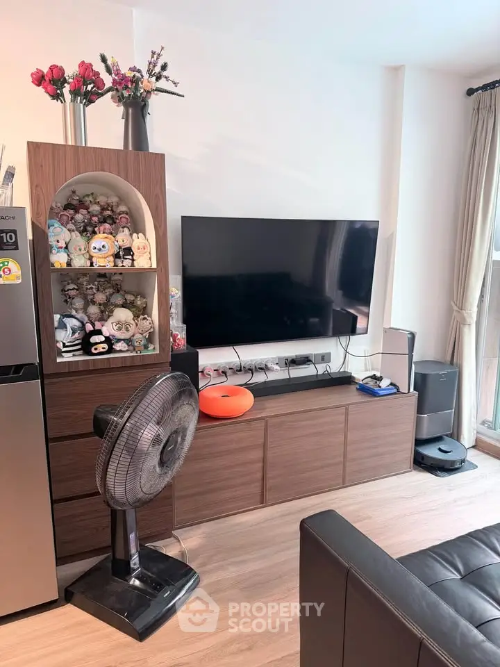 Modern living room with stylish decor, flat-screen TV, and elegant wooden furniture.