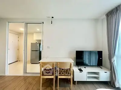 Modern living room with dining area and TV, featuring sleek furniture and natural light.