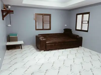 Spacious living room with modern sofa and elegant tiled flooring