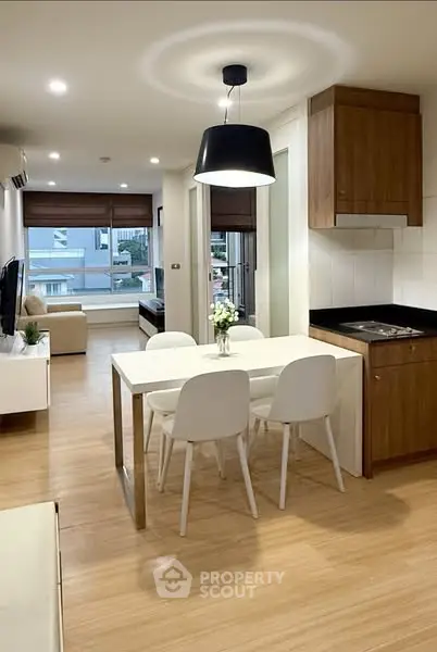Modern open-plan living room and kitchen with sleek design and natural light.