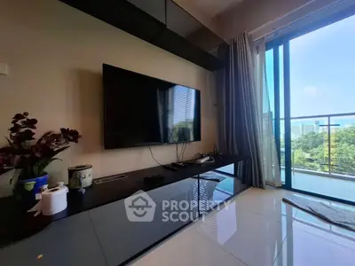 Modern living room with sleek TV setup and balcony view