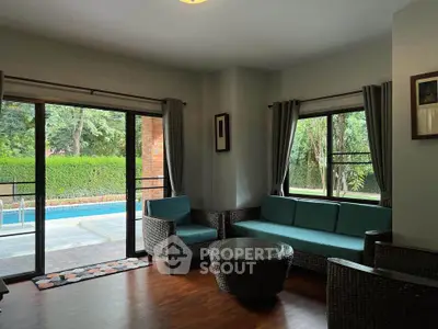 Spacious living room with pool view and modern furniture