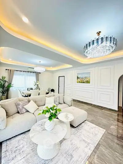 Luxurious living room with elegant chandelier and plush seating in modern home