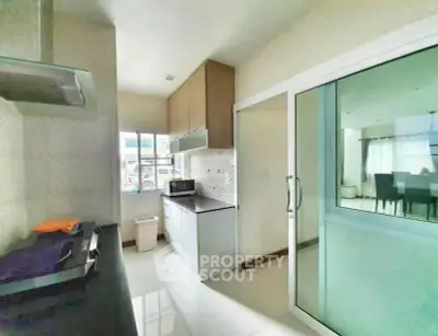 Modern kitchen with sleek design and sliding glass door