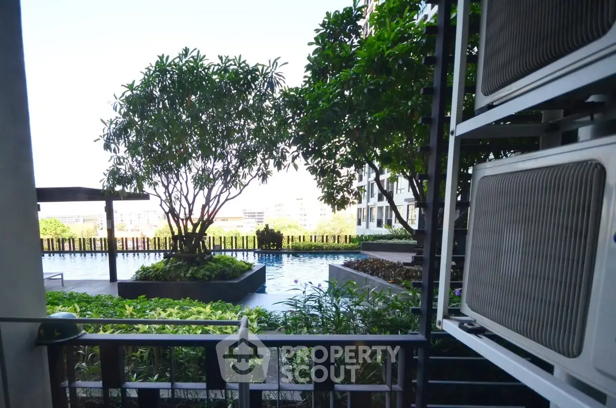 Stunning poolside view with lush greenery and modern architecture, perfect for relaxation and leisure.