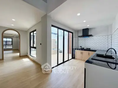 Modern open-layout kitchen with sleek design and natural light
