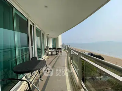 Stunning beachfront balcony with panoramic ocean views and modern outdoor seating.