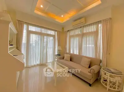 Elegant living room with large windows and cozy sofa, perfect for relaxation.