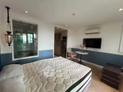 Cozy bedroom with modern decor, featuring a comfortable bed, wall-mounted TV, and stylish lighting.