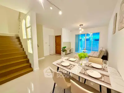 Spacious modern living room with elegant dining area and stylish staircase