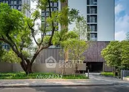 Modern residential building with lush green landscaping and contemporary design.