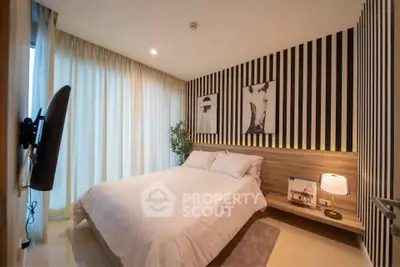 Modern bedroom with stylish decor and cozy ambiance, featuring a comfortable bed and elegant lighting.
