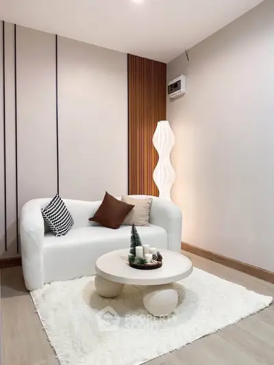 Modern living room with stylish white sofa and unique round coffee table