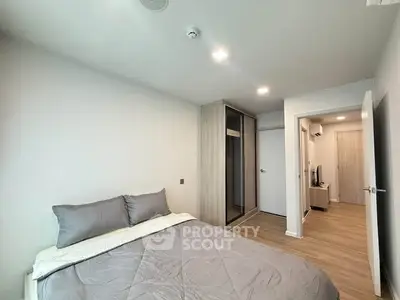 Modern bedroom with sleek design and ample storage in a contemporary apartment.