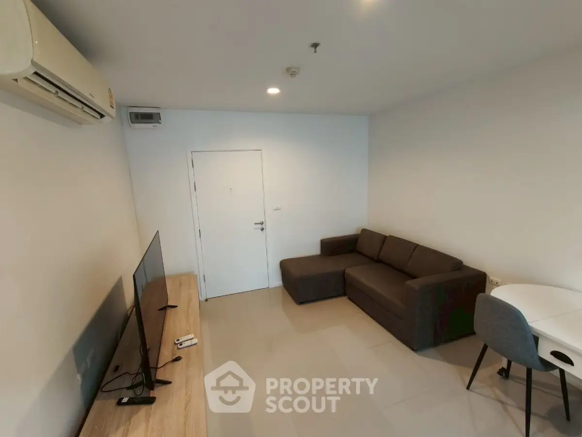 Modern living room with sleek furniture and air conditioning, perfect for comfortable living.