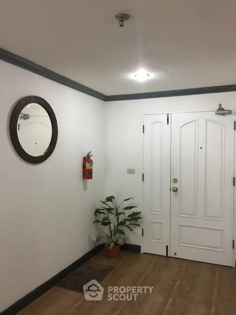 Stylish apartment entrance with white door and elegant decor