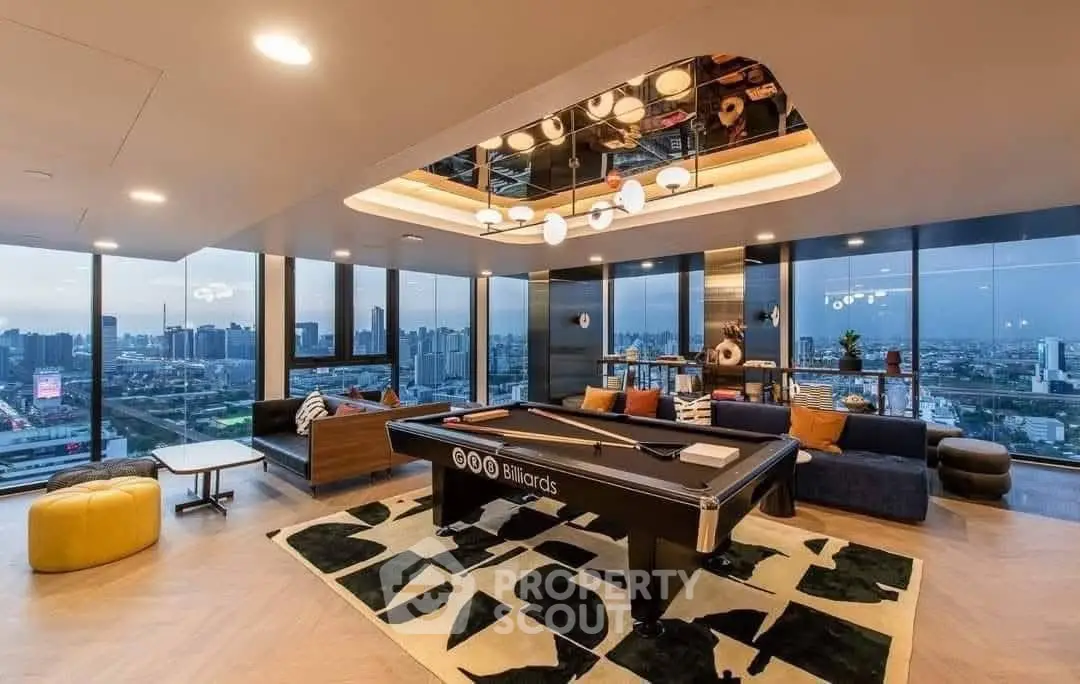 Luxurious high-rise living room with billiards table and panoramic city views.