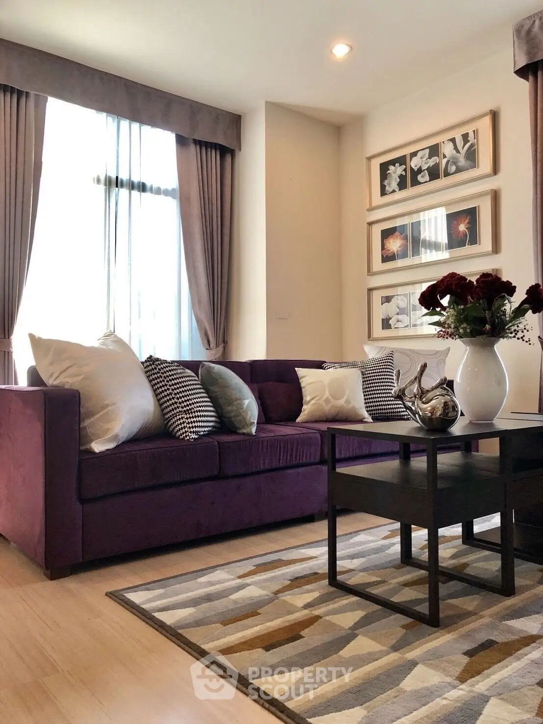 Elegant living room with plush purple sofa and stylish decor