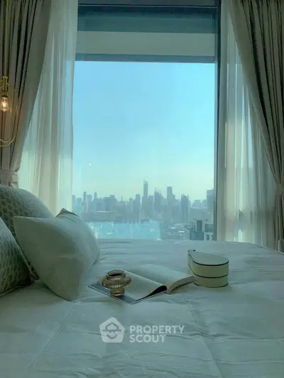 Luxurious bedroom with stunning city skyline view through large window, elegant decor and plush bedding.