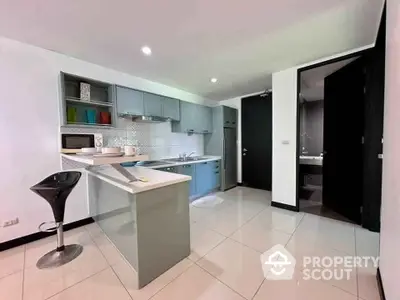 Modern kitchen with sleek cabinetry and breakfast bar in stylish apartment