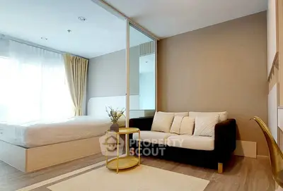 Modern bedroom with cozy sofa and elegant decor