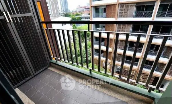 Charming balcony view in modern apartment with cityscape backdrop.