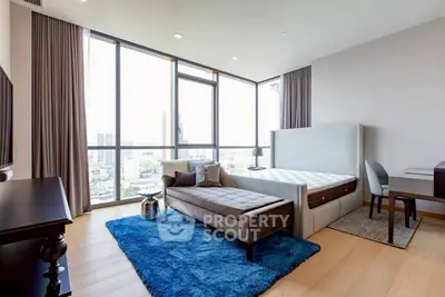 Spacious modern bedroom with large windows and city view