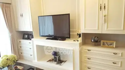 Elegant living room with built-in cabinets and modern TV setup