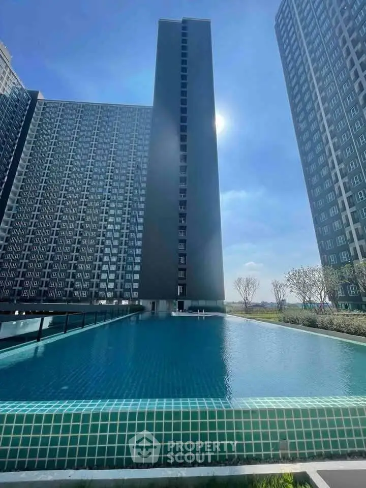 Stunning modern high-rise building with a luxurious rooftop pool and panoramic city views.