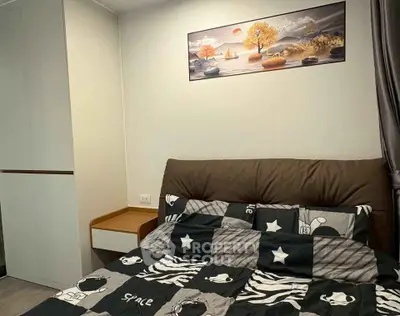 Cozy bedroom with modern decor and stylish bedding in a contemporary apartment.