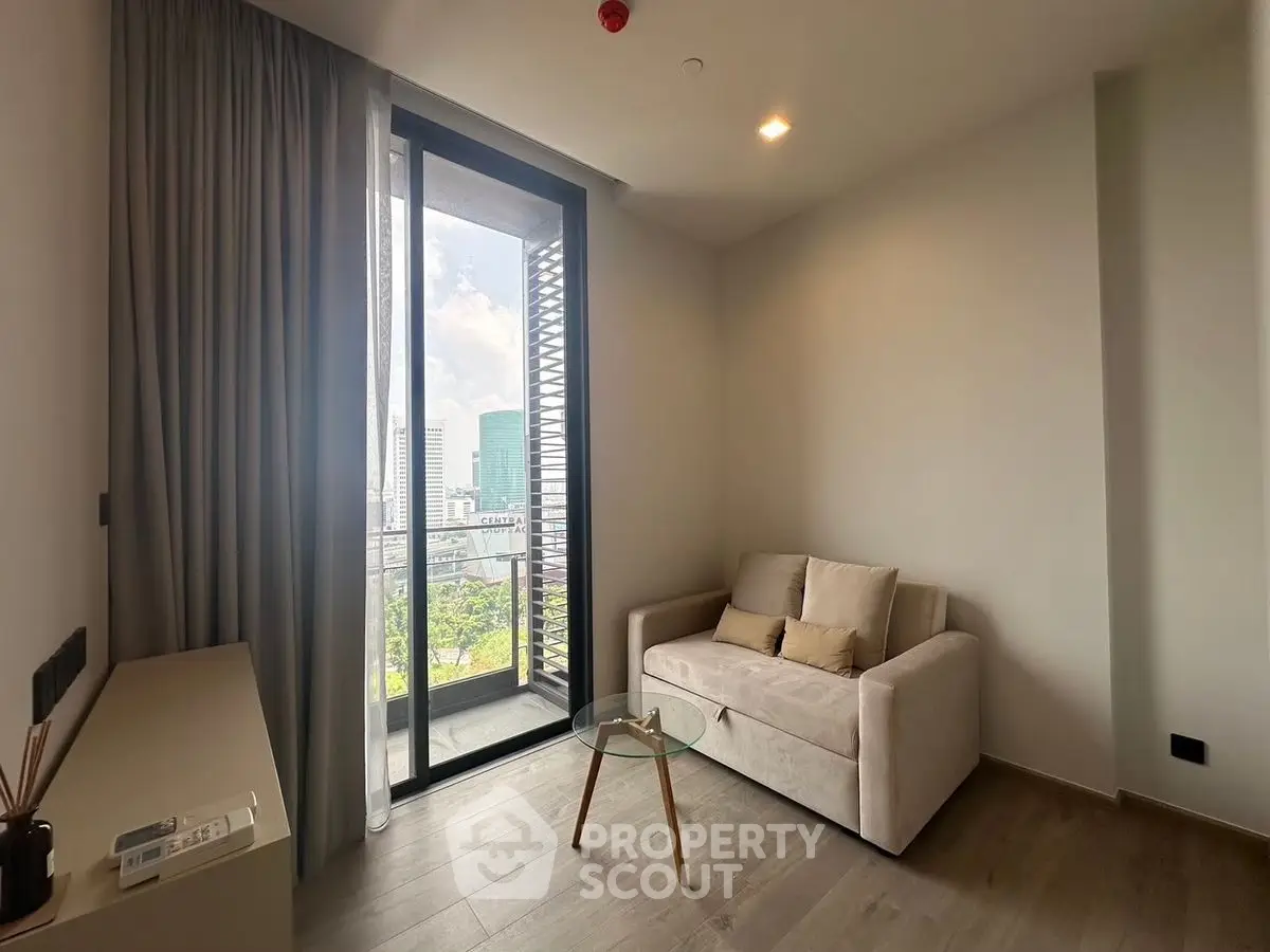 Modern living room with city view and cozy sofa near balcony.