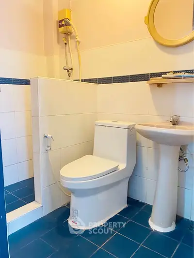 Modern bathroom with blue tiles and sleek fixtures