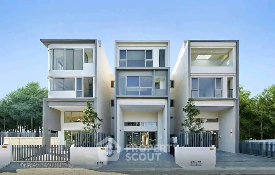 Modern architectural masterpiece with sleek design and large windows in a serene neighborhood.