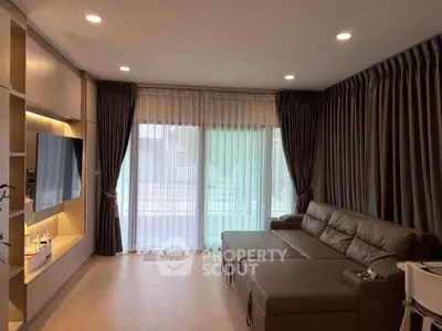 Spacious modern living room with elegant curtains and cozy sectional sofa