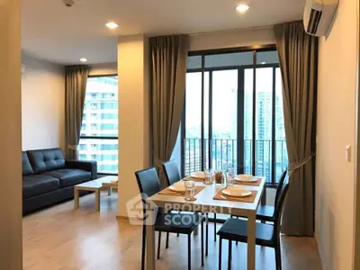 Modern living room with dining area and city view from balcony