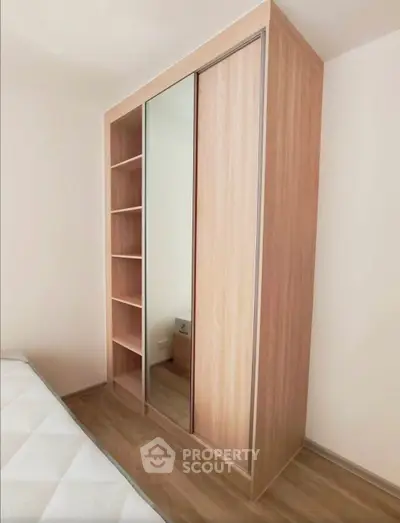 Modern bedroom with sleek wooden wardrobe and cozy ambiance