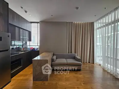 Modern kitchen and living area with sleek design and natural light