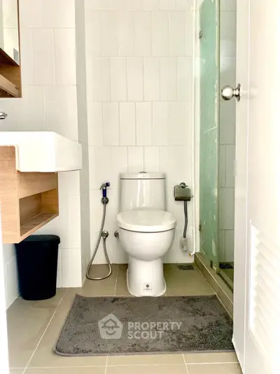 Modern bathroom with sleek design and glass shower enclosure.