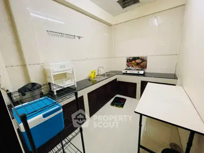 Compact kitchen with modern appliances and sleek countertops