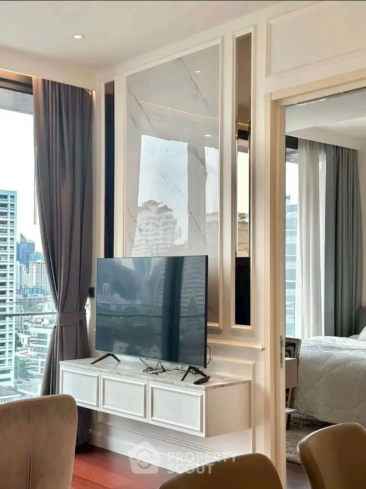 Modern living room with TV and city view in luxury apartment