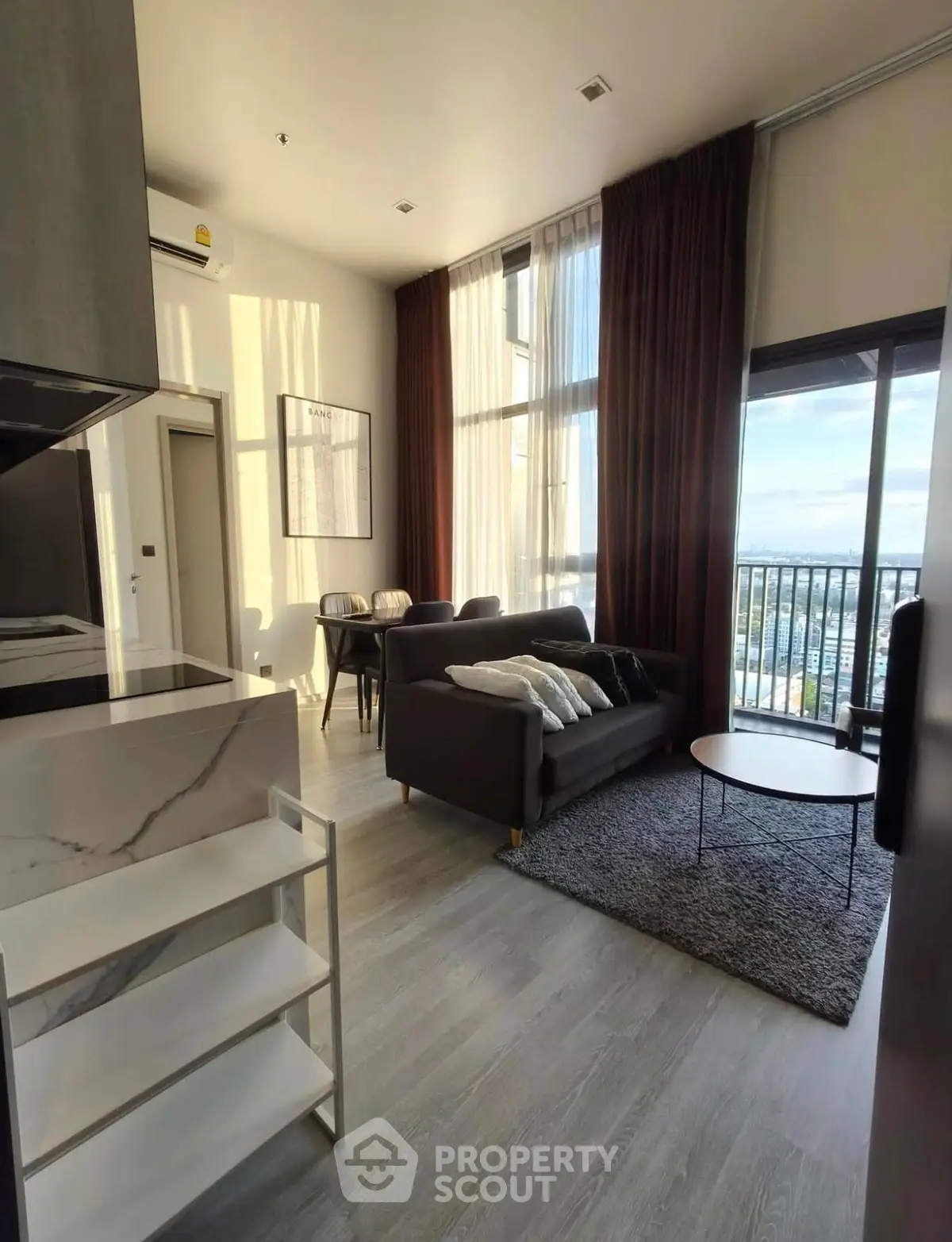 Modern living room with high ceilings and large windows offering stunning views.